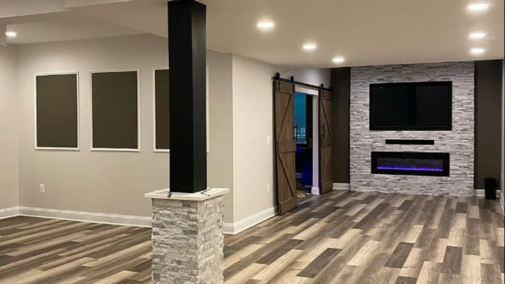 Basement bar with stone backsplash, wood shelves, wine coolers, and a long countertop.