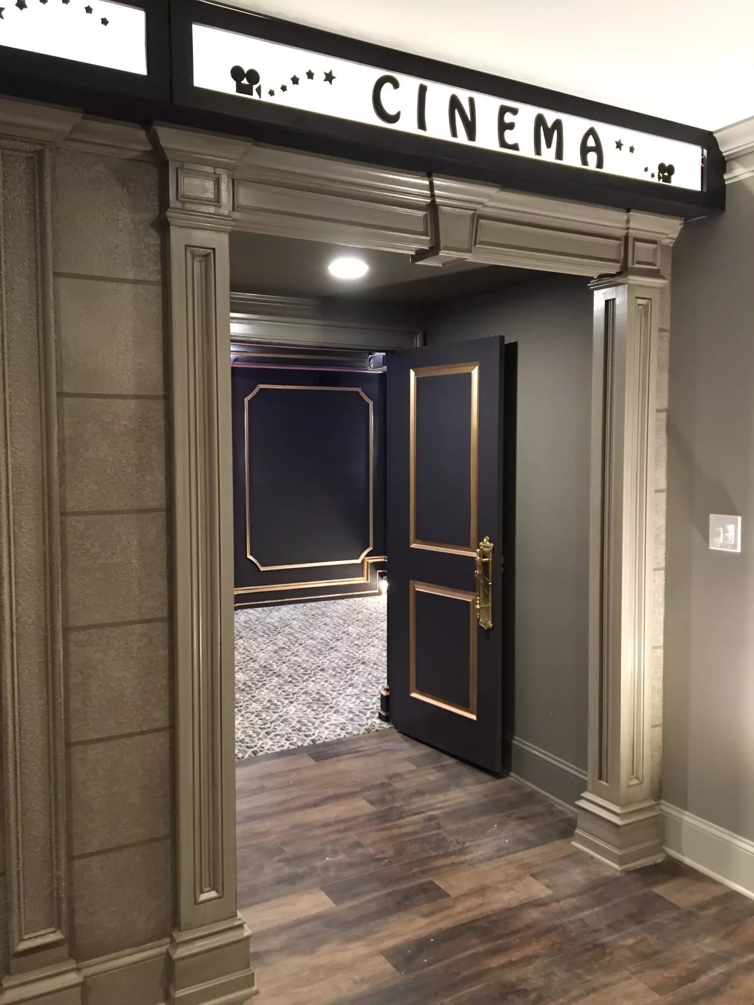 Entrance to a home cinema room. Sign reads 