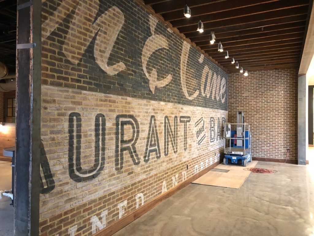 Brick wall with painted sign: 