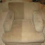 Beige upholstered armchair with padded arms and seat, shown against a plain background.