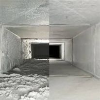 Split-view of a square HVAC duct interior, half filled with snow and half clean metal.