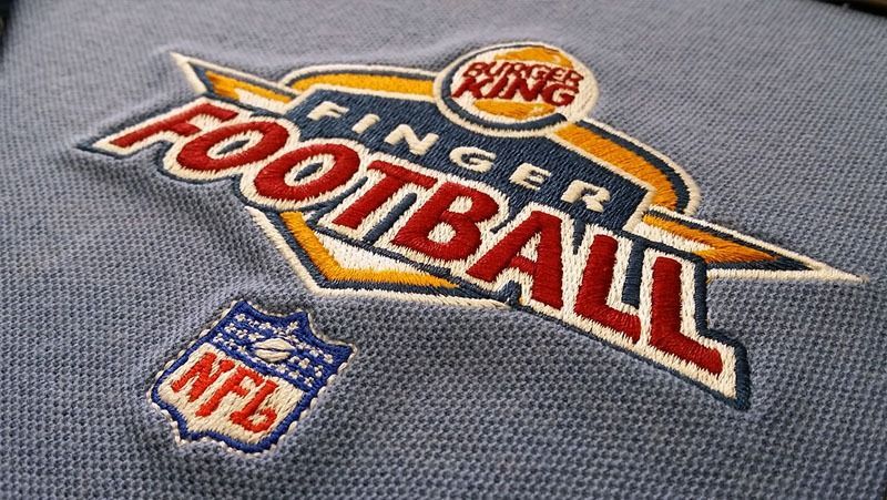 A close up of a shirt that says finger football