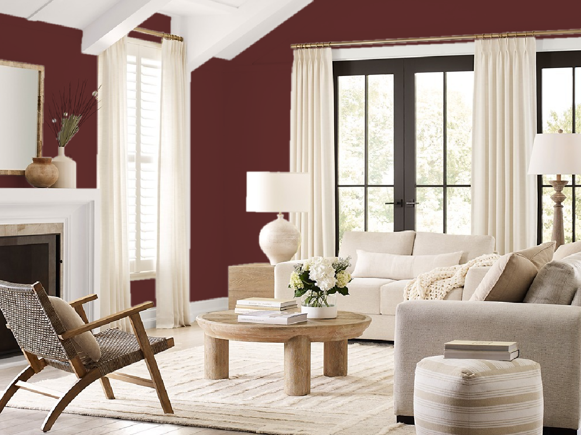 Living room with burgundy walls, white trim, beige sofa, and natural wood furniture.