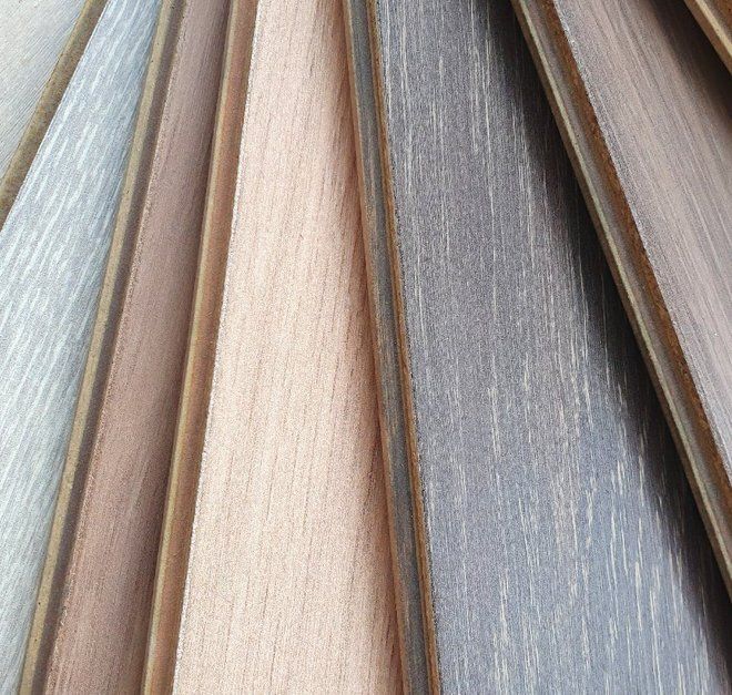 Close-up of wooden floorboards in various neutral colors, fanned out for display.