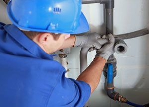 A plumber installing pipe