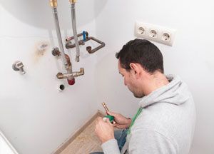 A man installing water heater