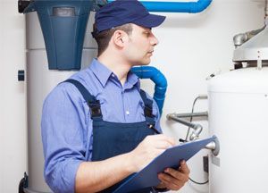 A technician servicing water heaters