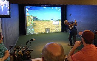 People playing golf simulator