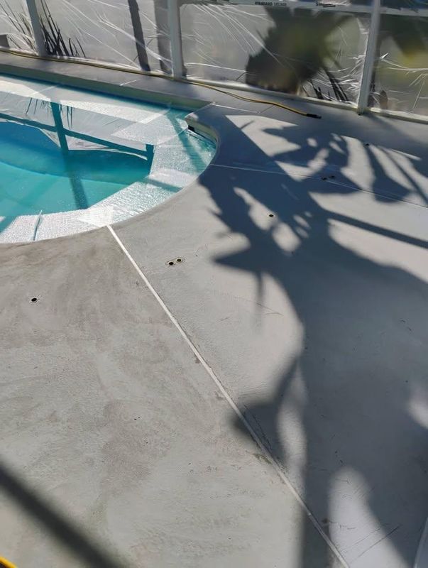 Poolside patio with turquoise water, curved white edge, and palm tree shadows on concrete.