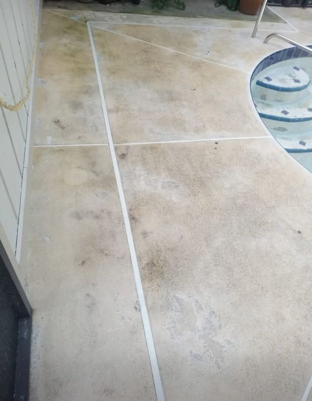 Beige tiled floor with white grout lines and a blue-edged round table at the side