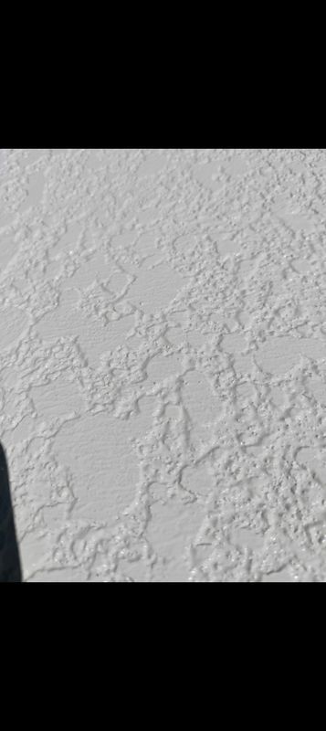 Close-up of a white textured plaster wall surface