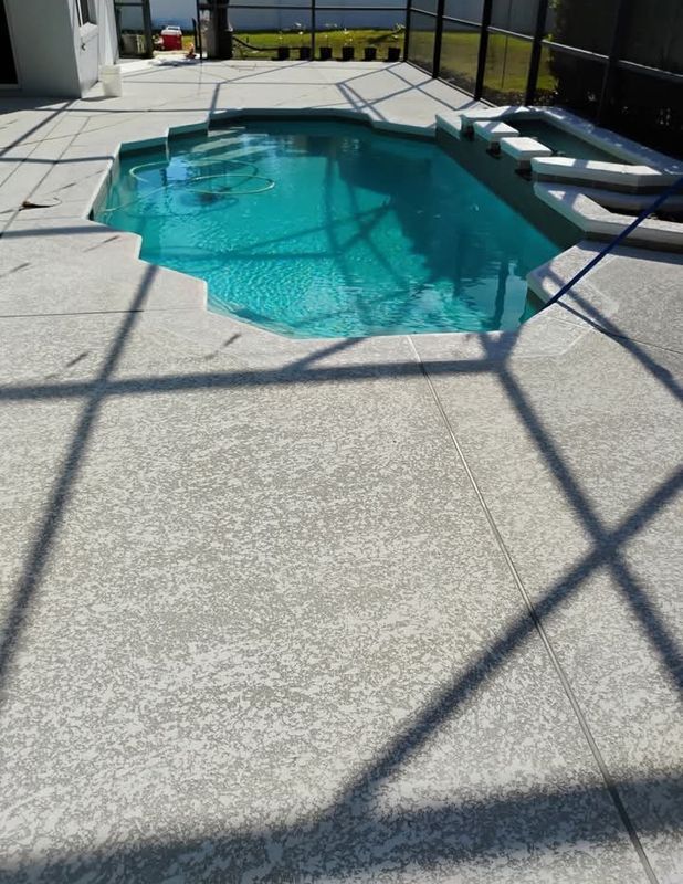 Screened backyard pool with turquoise water and white lounge chairs on a sunlit patio.