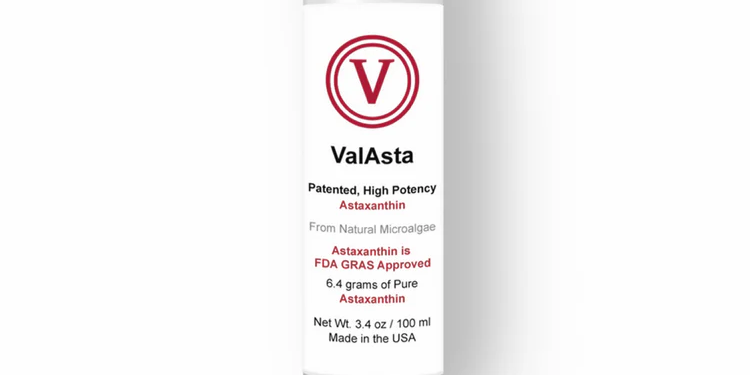 A bottle of valasta is sitting on a white surface.