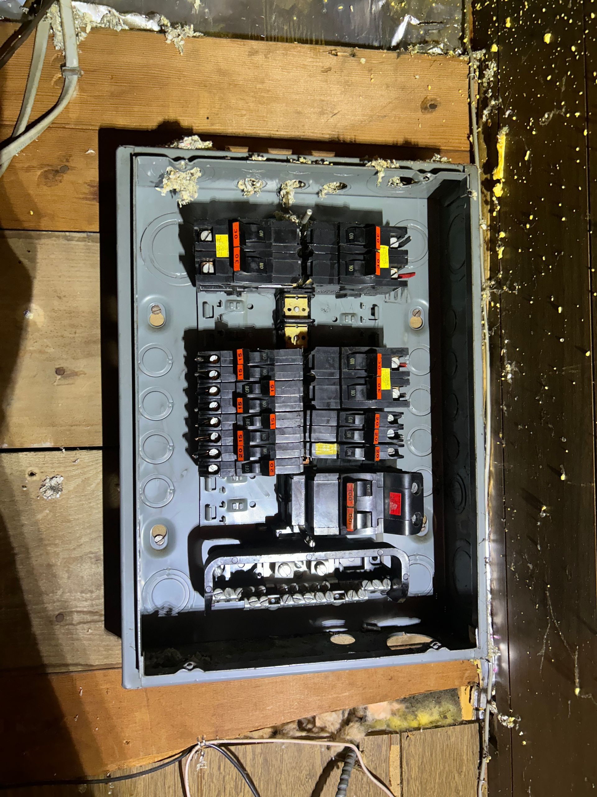 An old electrical box is sitting on a wooden floor