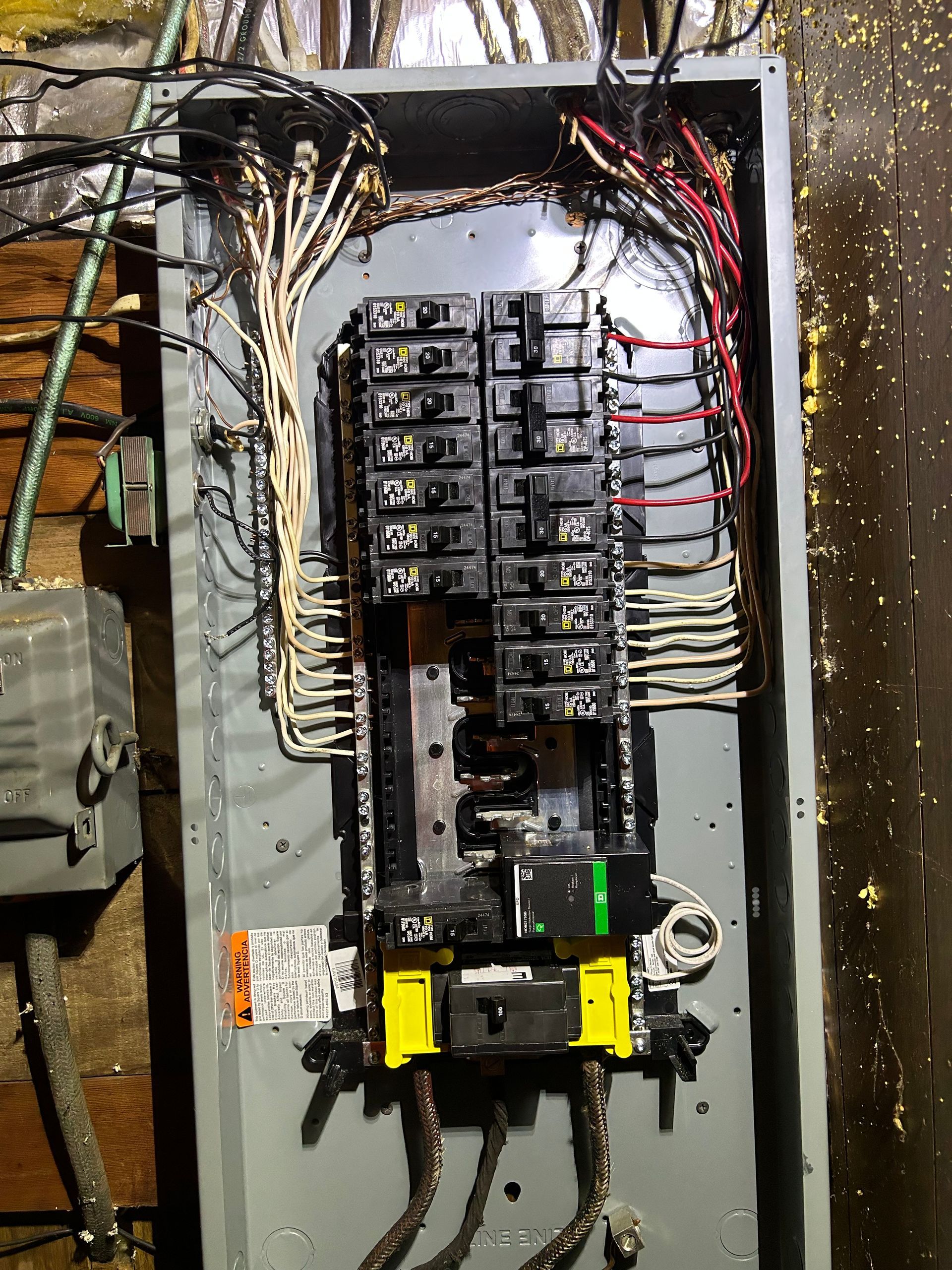 A very old electrical box with a lot of wires coming out of it.