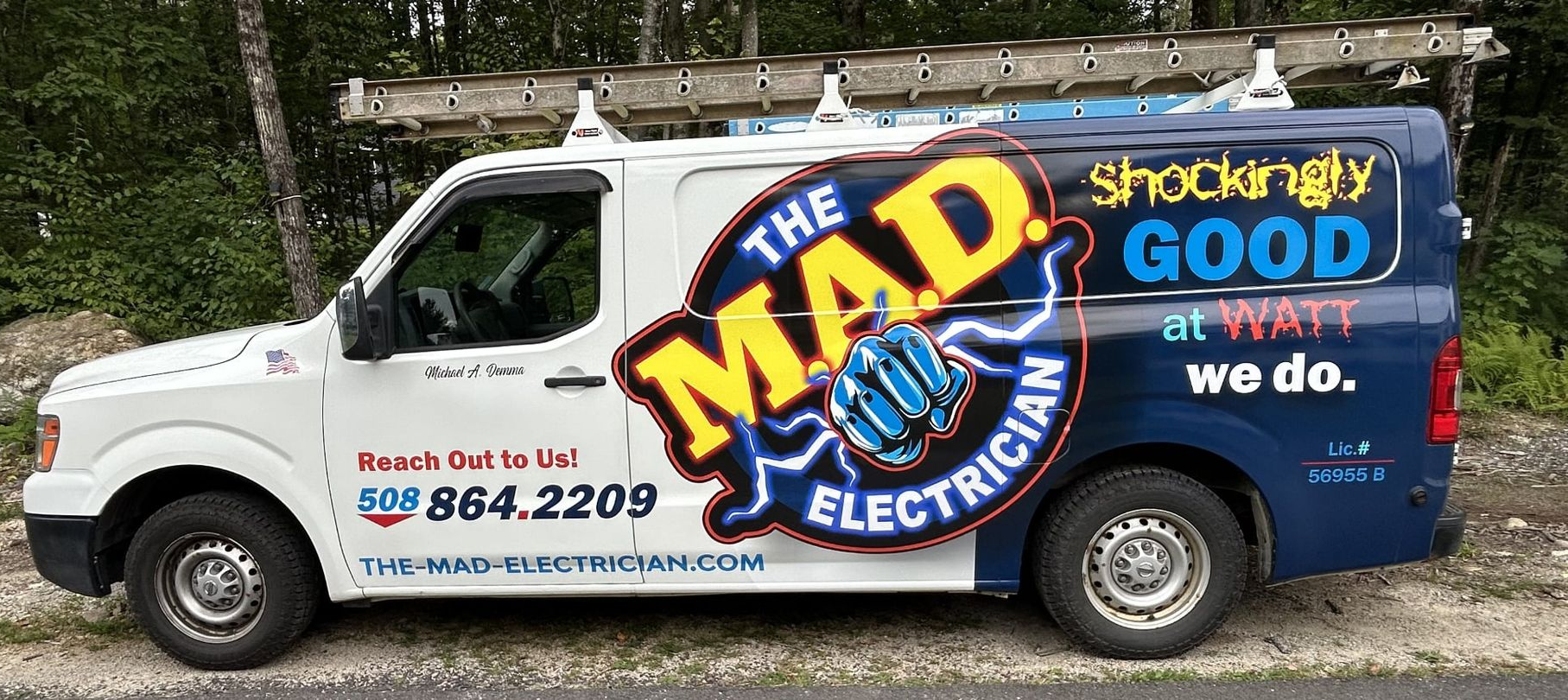 White and blue van with The Mad Electrician logo