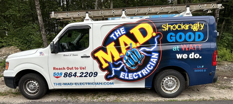 White and blue van with The Mad Electrician logo