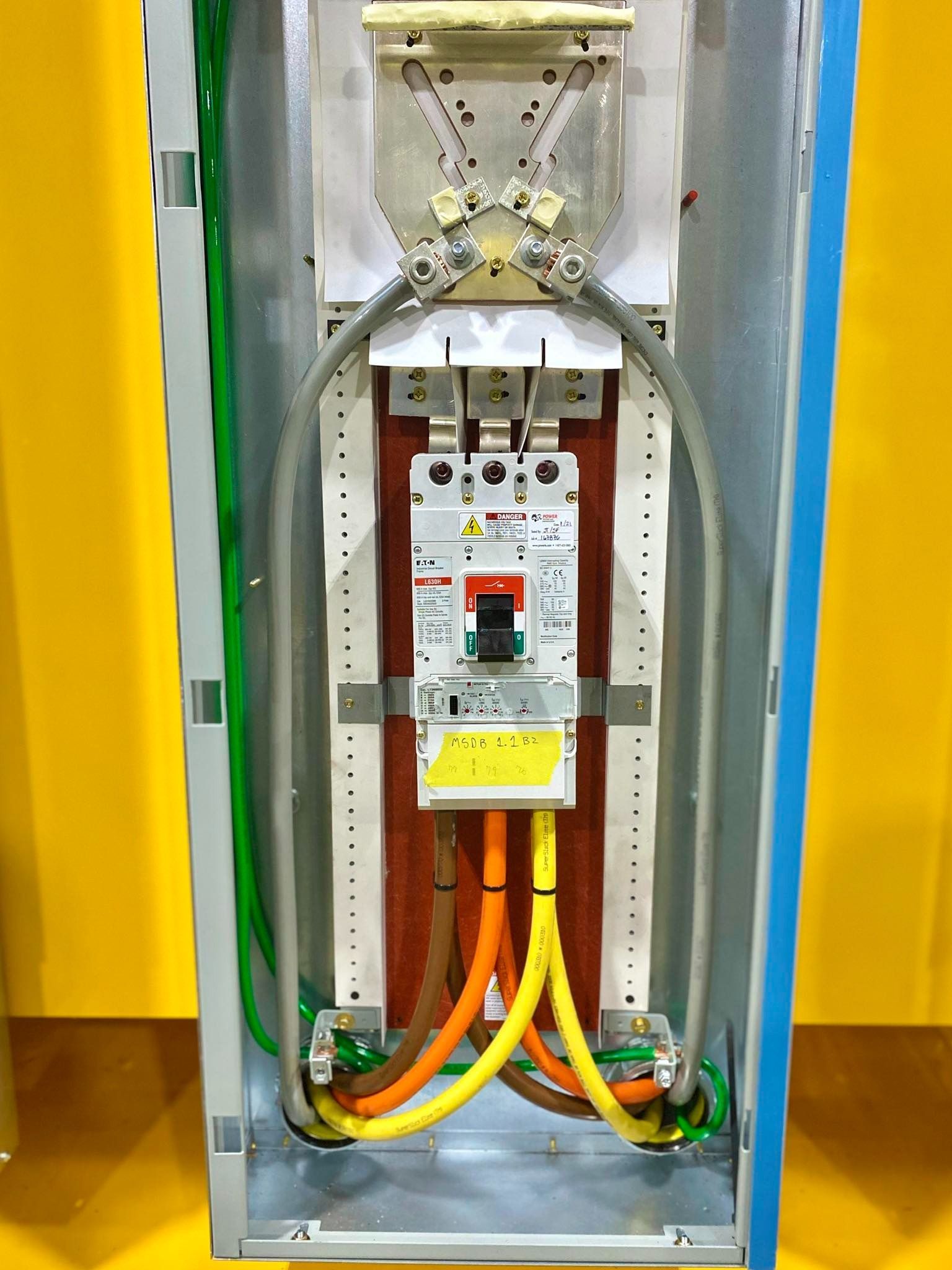 The inside of an electrical box with a breaker and wires