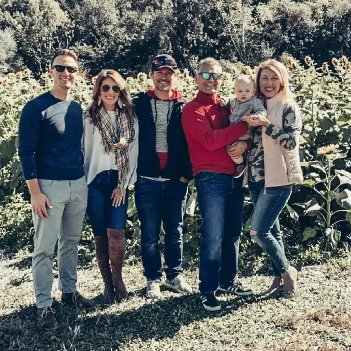 A group of people posing for a picture in a field