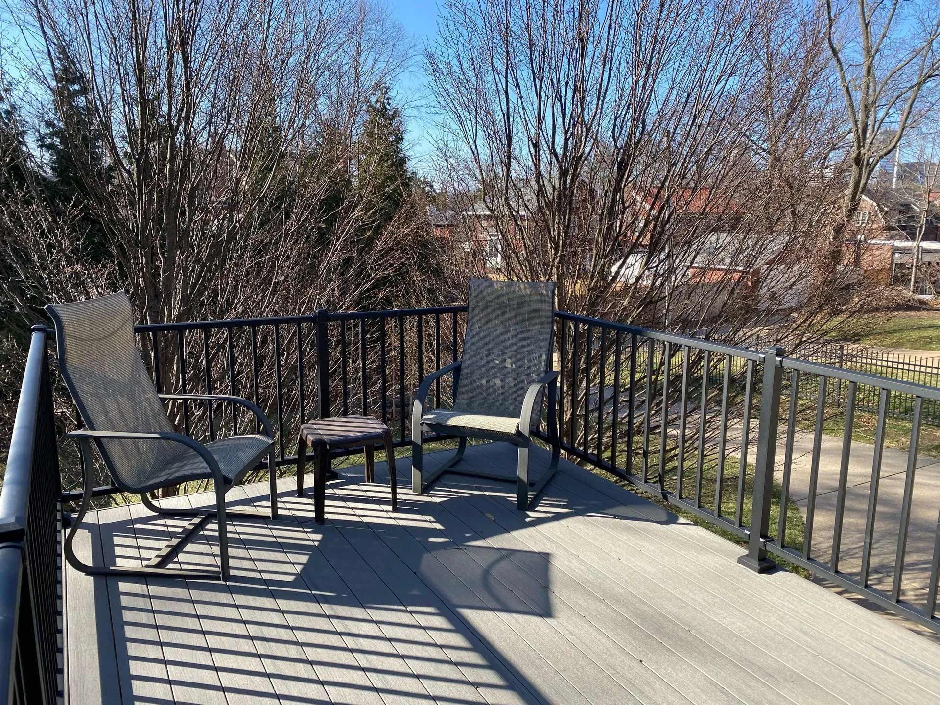 A deck with rocking chairs and a table on it