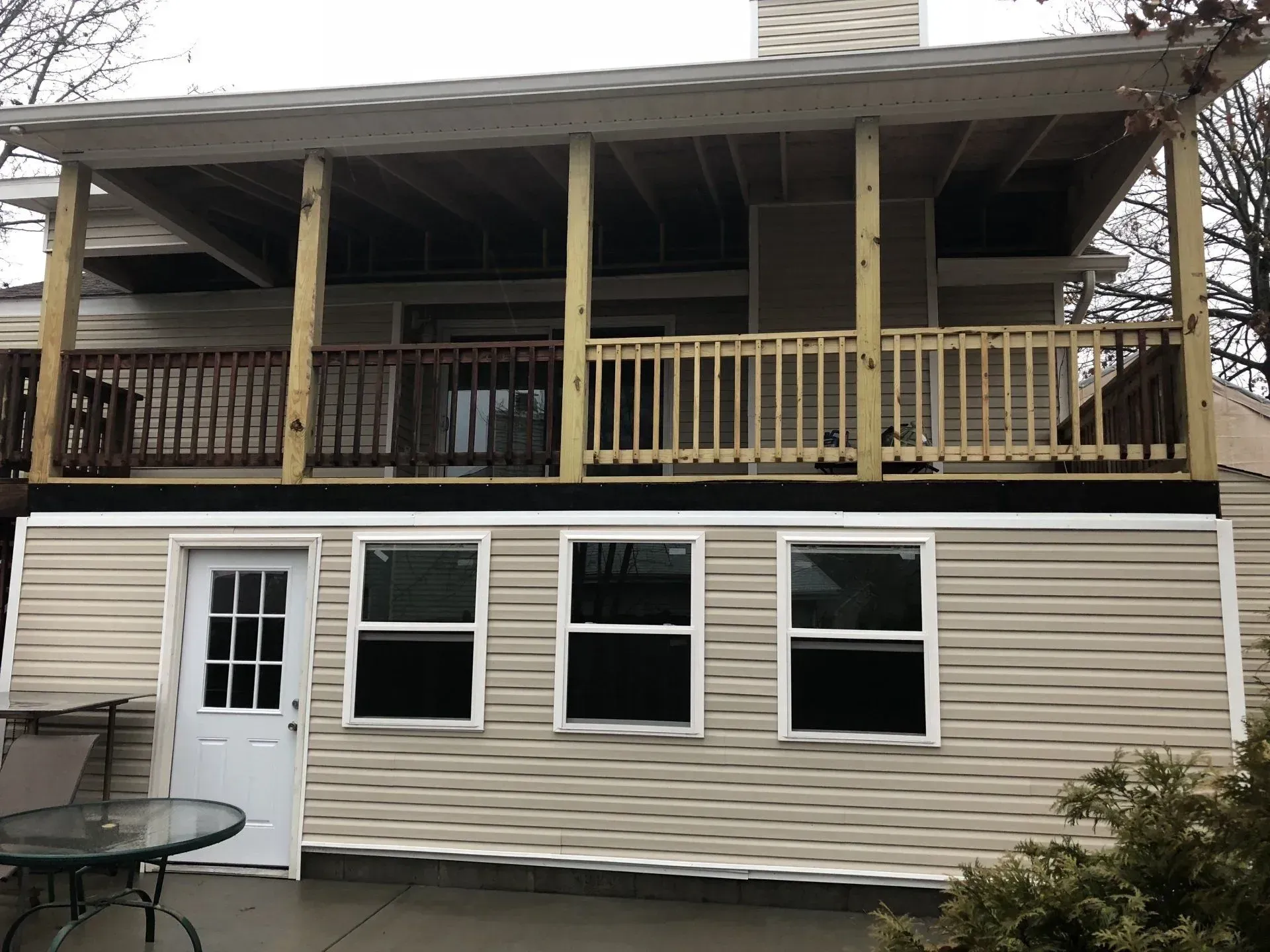 A house with a deck and a table in front of it