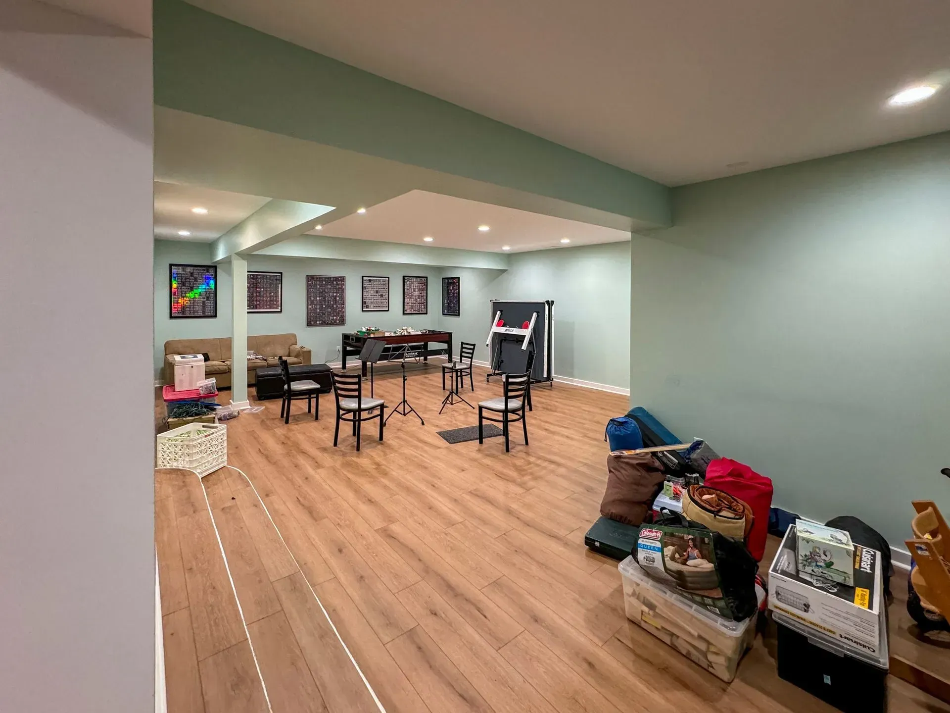 A large room with wooden floors and a lot of furniture in it.