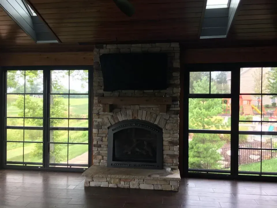 A living room with a fireplace and a flat screen tv.