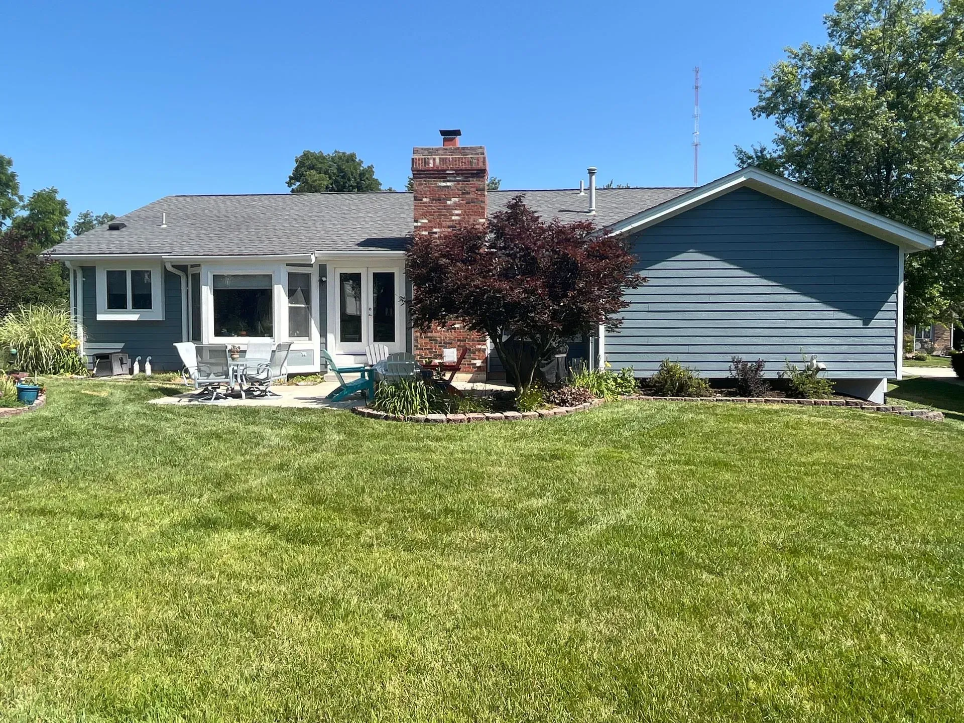 A house with a large lawn in front of it