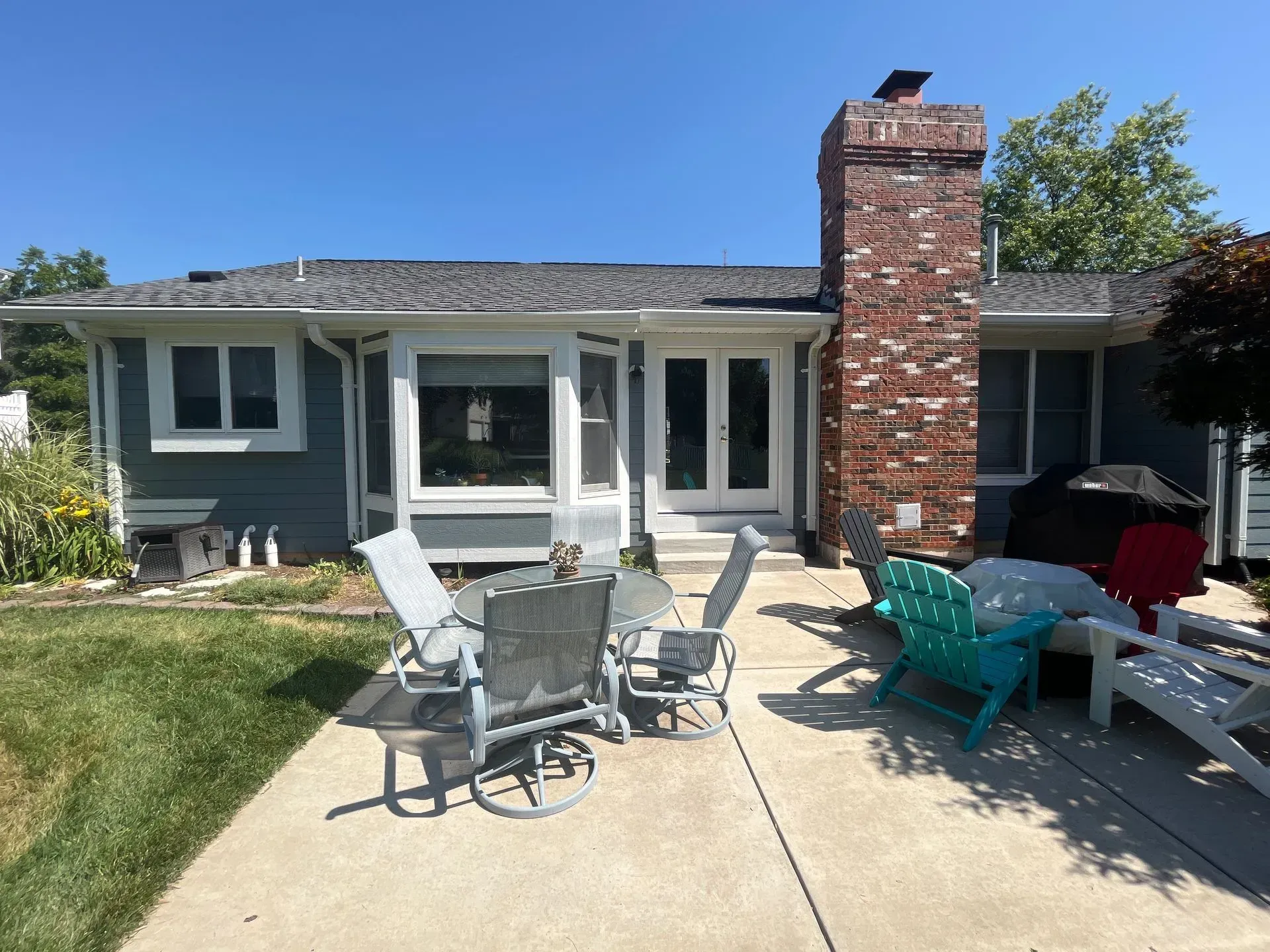 A house with a table and chairs in front of it