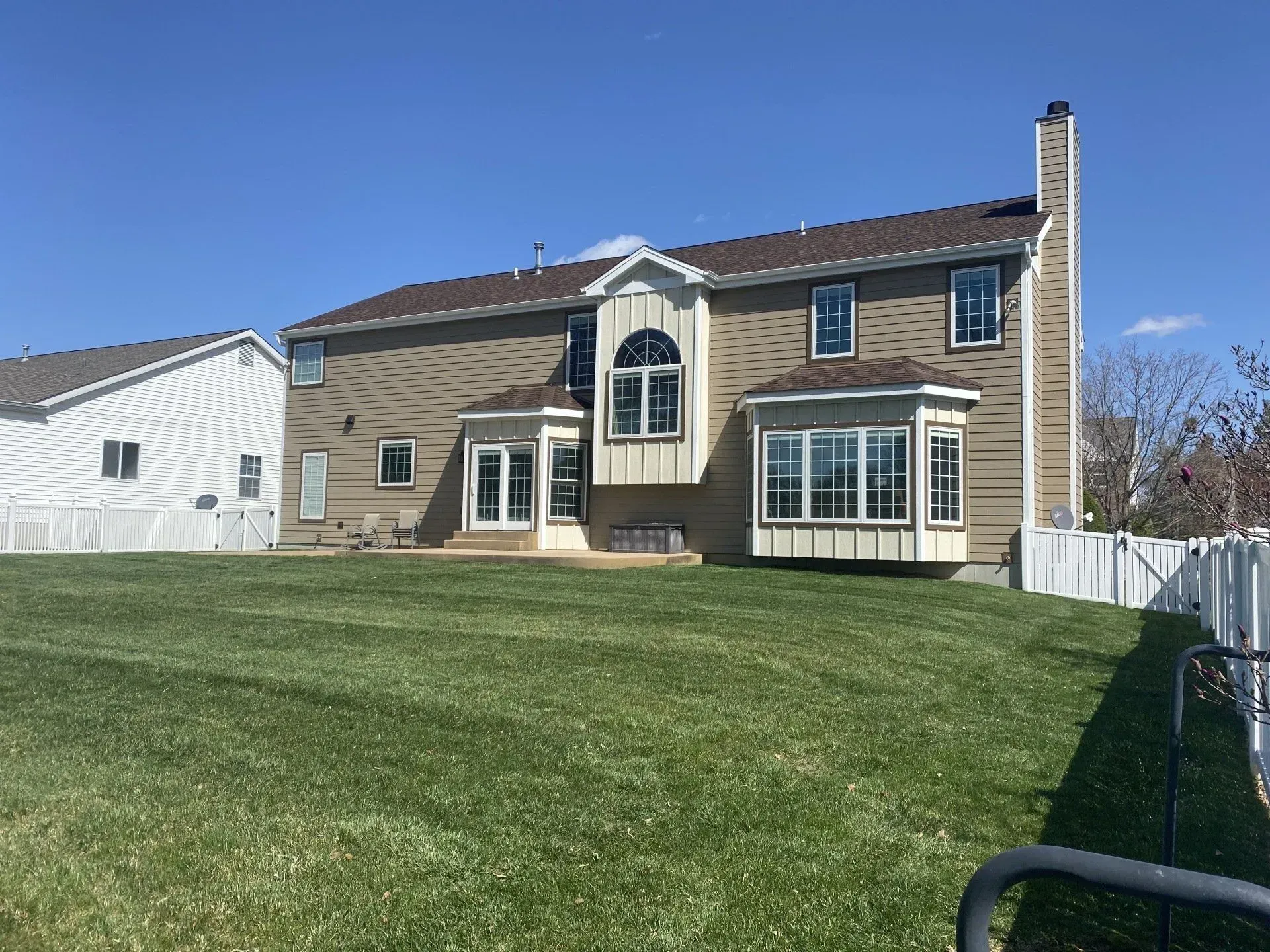 A large house with a large lawn in front of it.