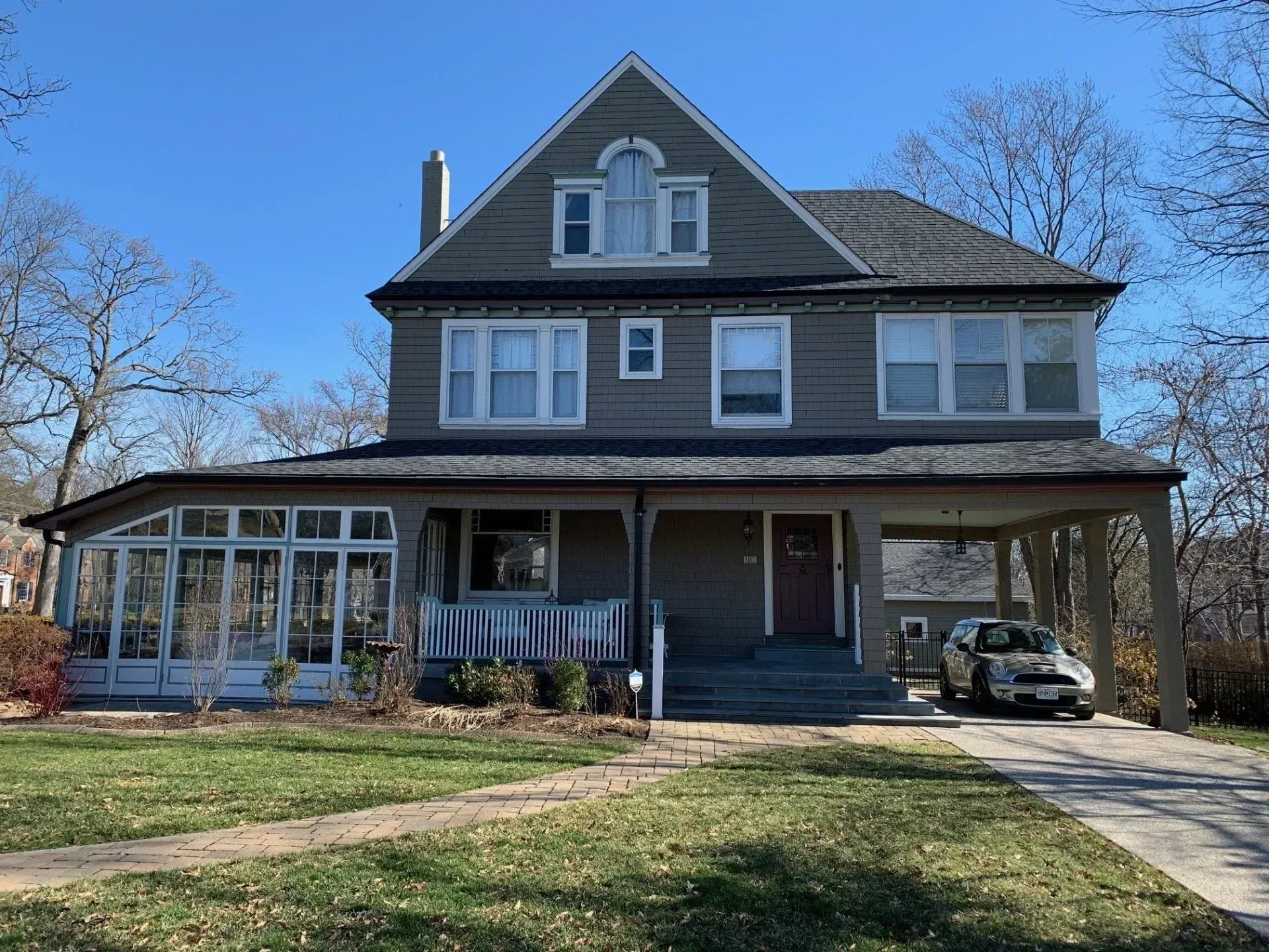 A large house with a car parked in front of it.