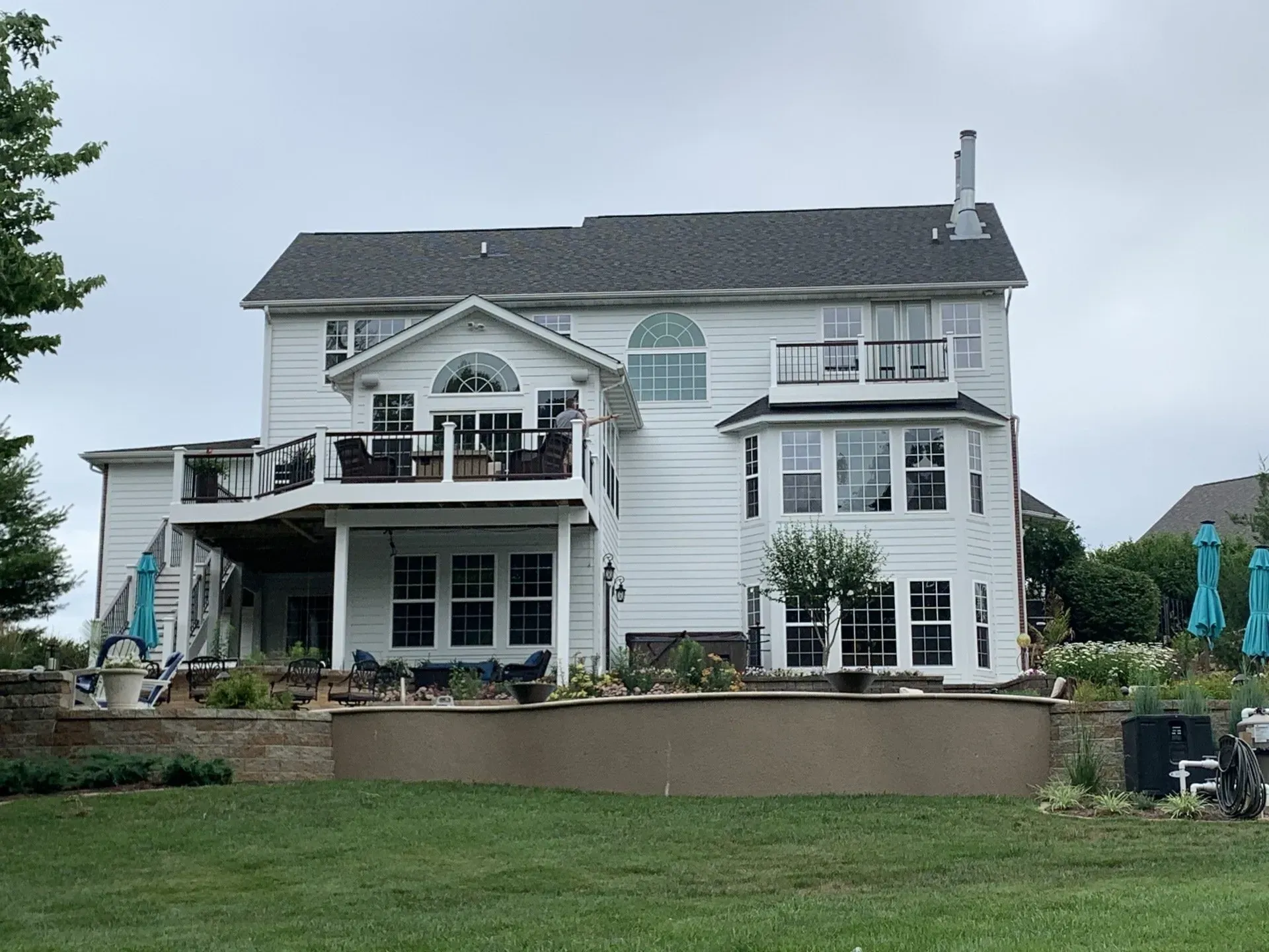 A large white house with a large lawn in front of it.