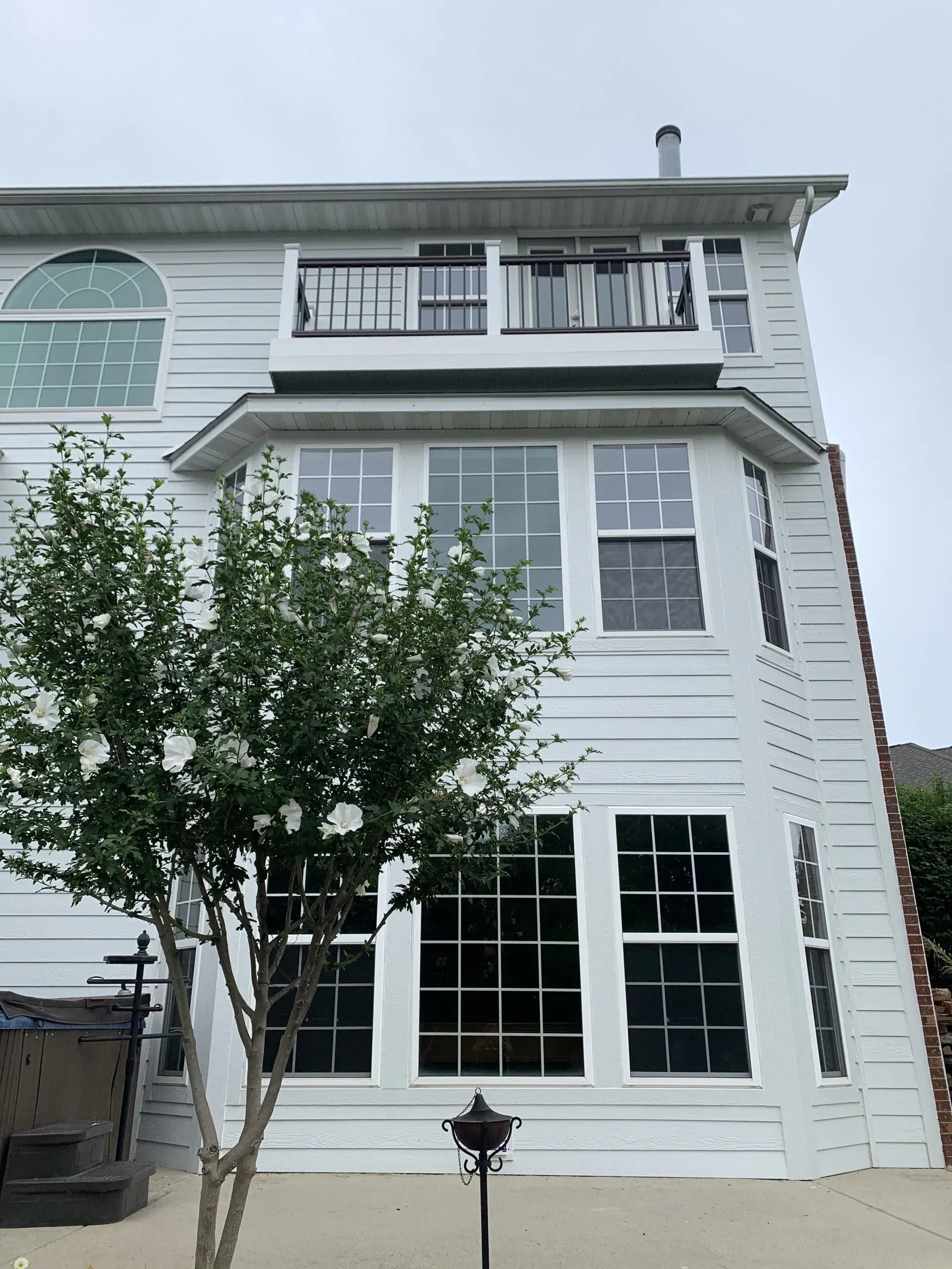 A large white house with a tree in front of it