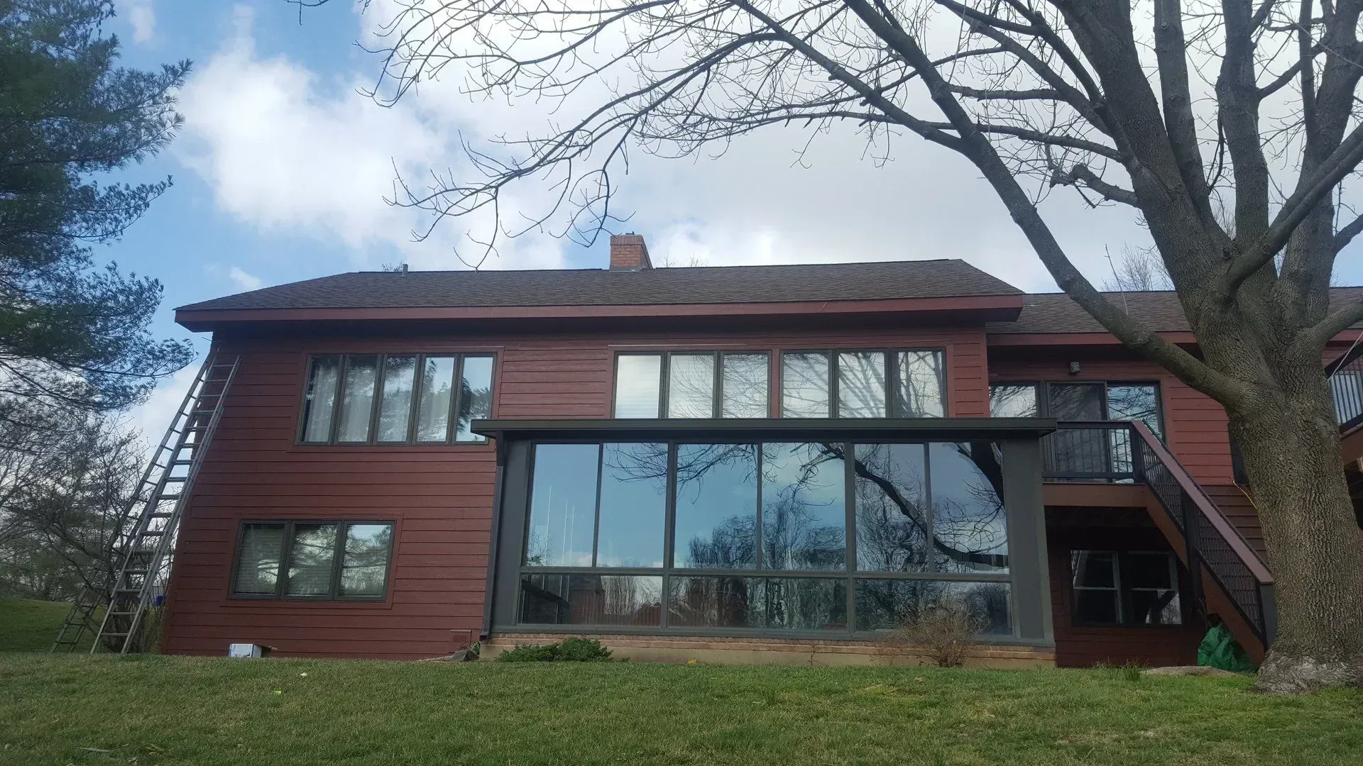 A large house with a lot of windows and a tree in front of it.