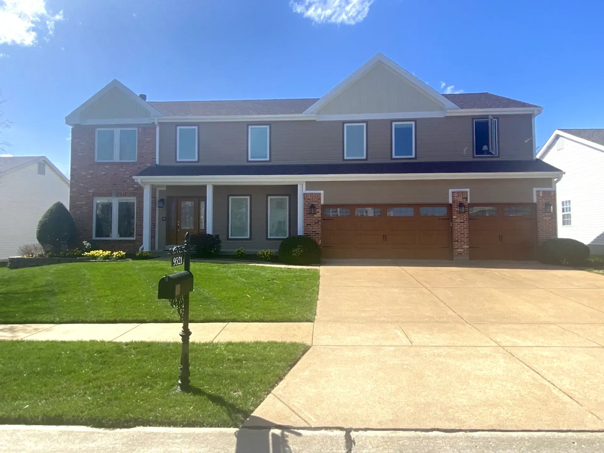 A large house with a mailbox in front of it.