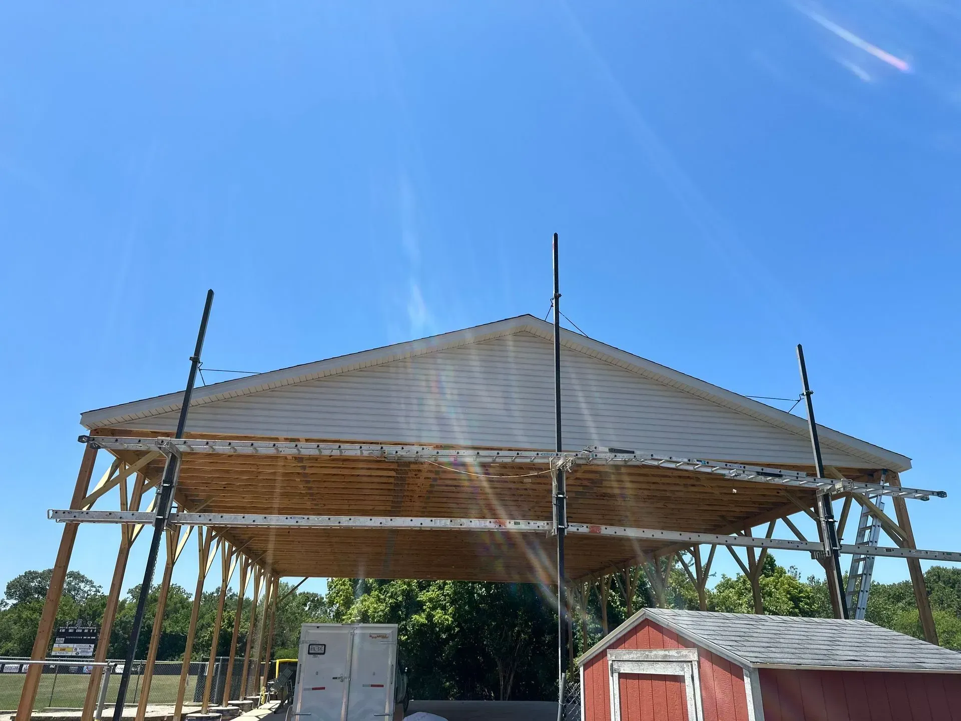 A large building under construction with a blue sky in the background.