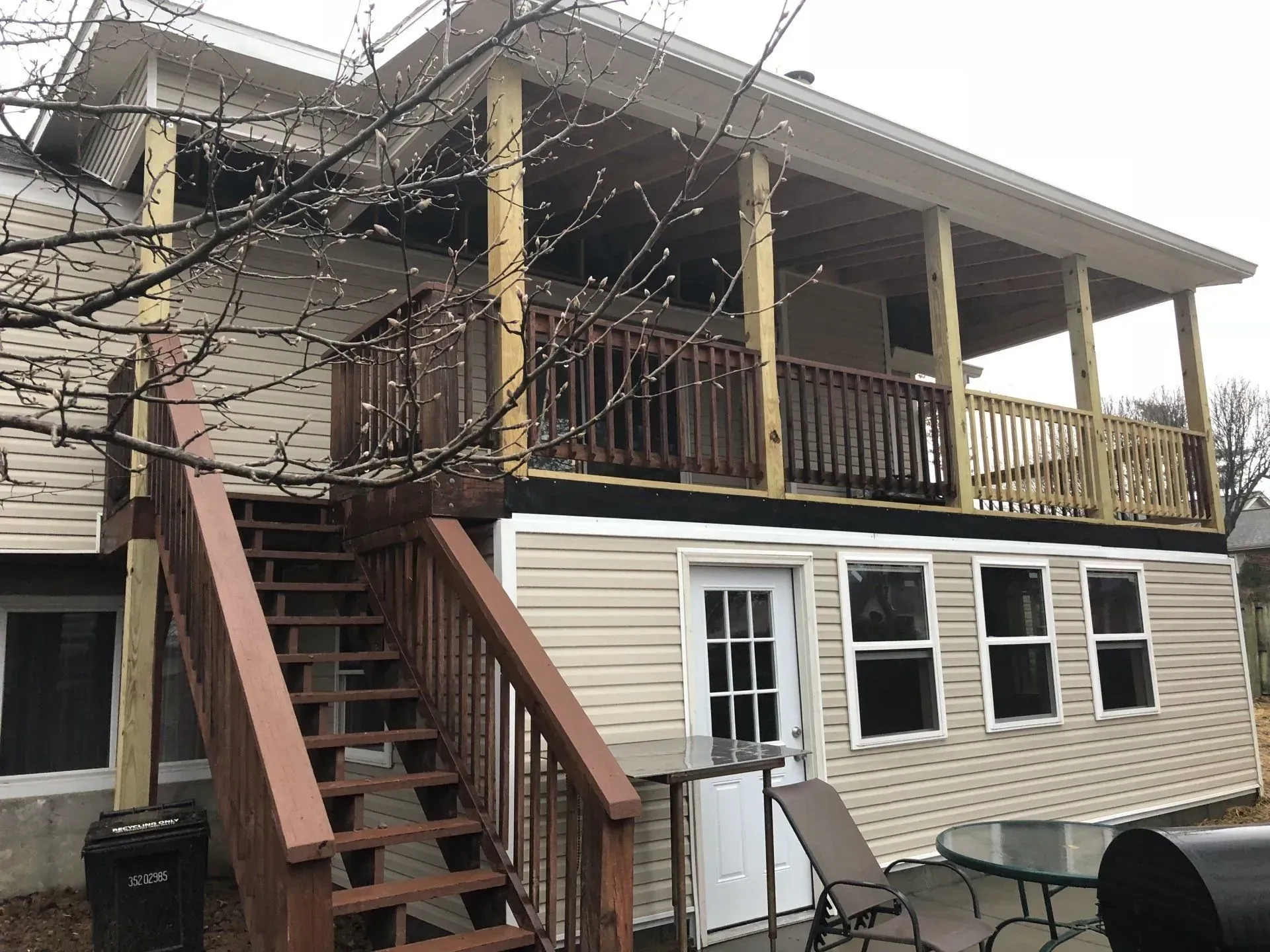 A house with a large deck and stairs leading up to it.