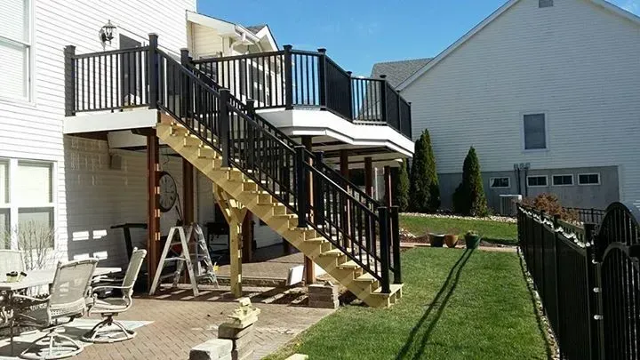 A wooden deck with stairs leading up to it