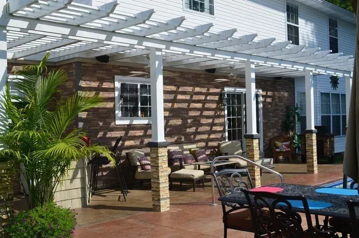 A patio with a table and chairs under a pergola