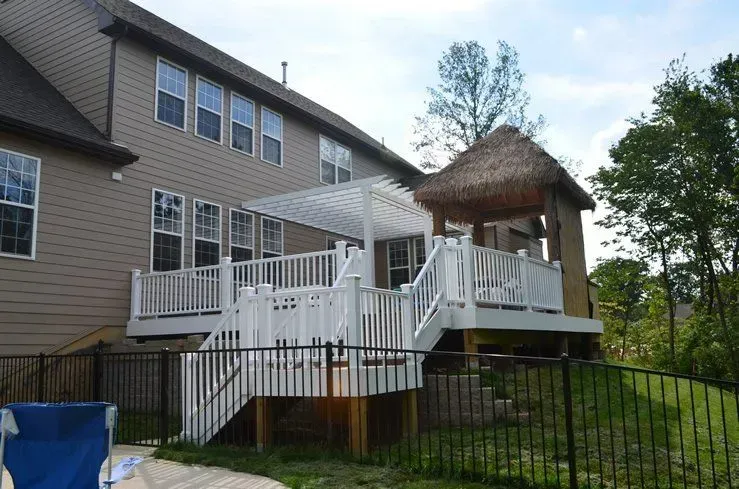 A large house with a large deck and a gazebo