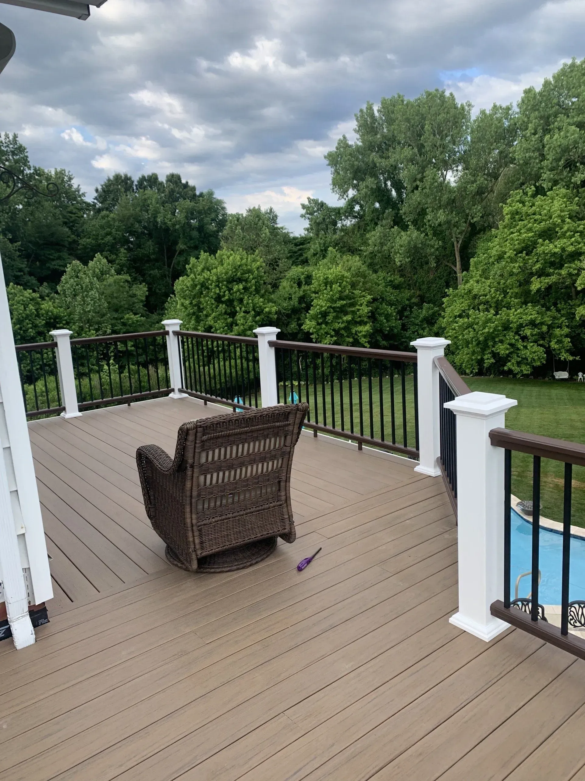 A deck with a chair and a fence surrounding it