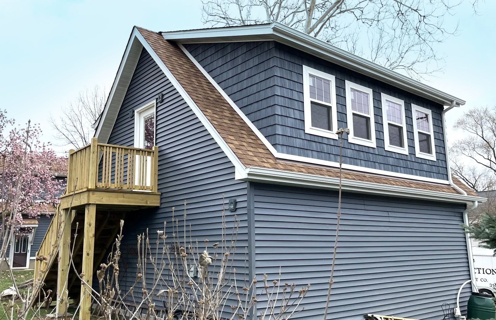 A small house with a balcony on the top of it.