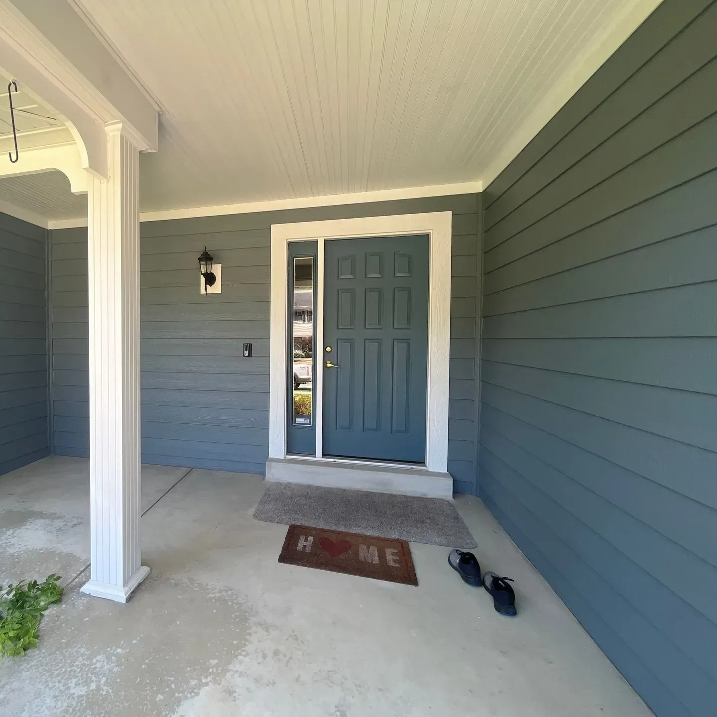 The front door of a house has a welcome mat in front of it
