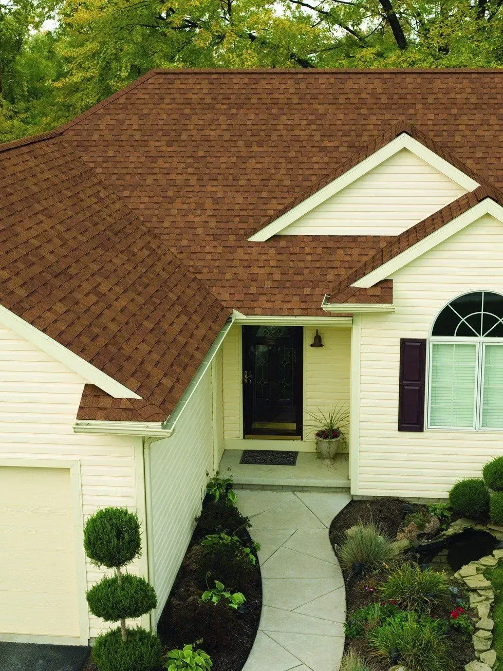 A house with a brown roof and white siding.