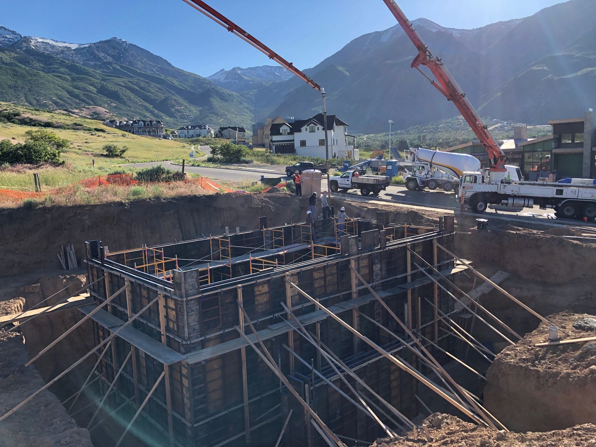 A construction site with a crane and mountains in the background