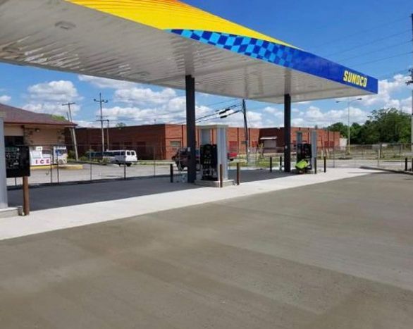 A gas station with a yellow and blue canopy and the word service on it