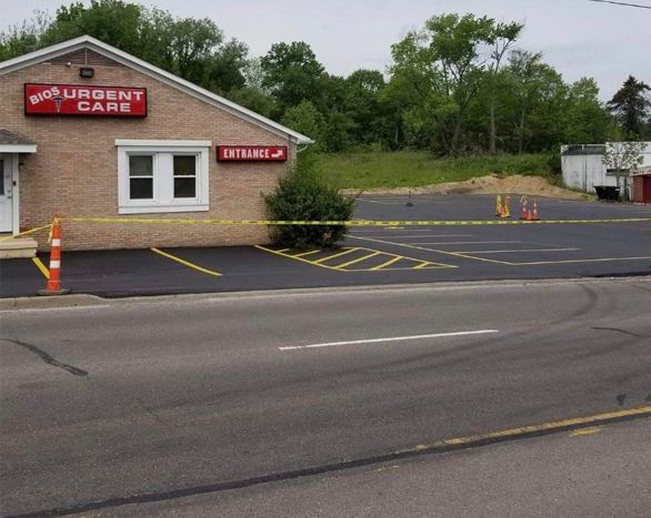 A brick building with a red sign that says urgent care