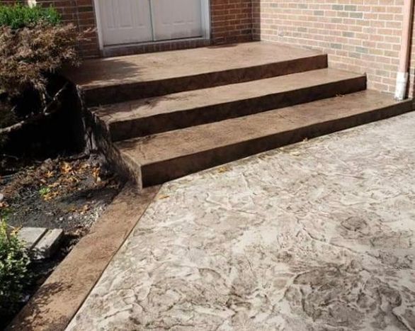 A set of concrete steps leading up to a brick building.