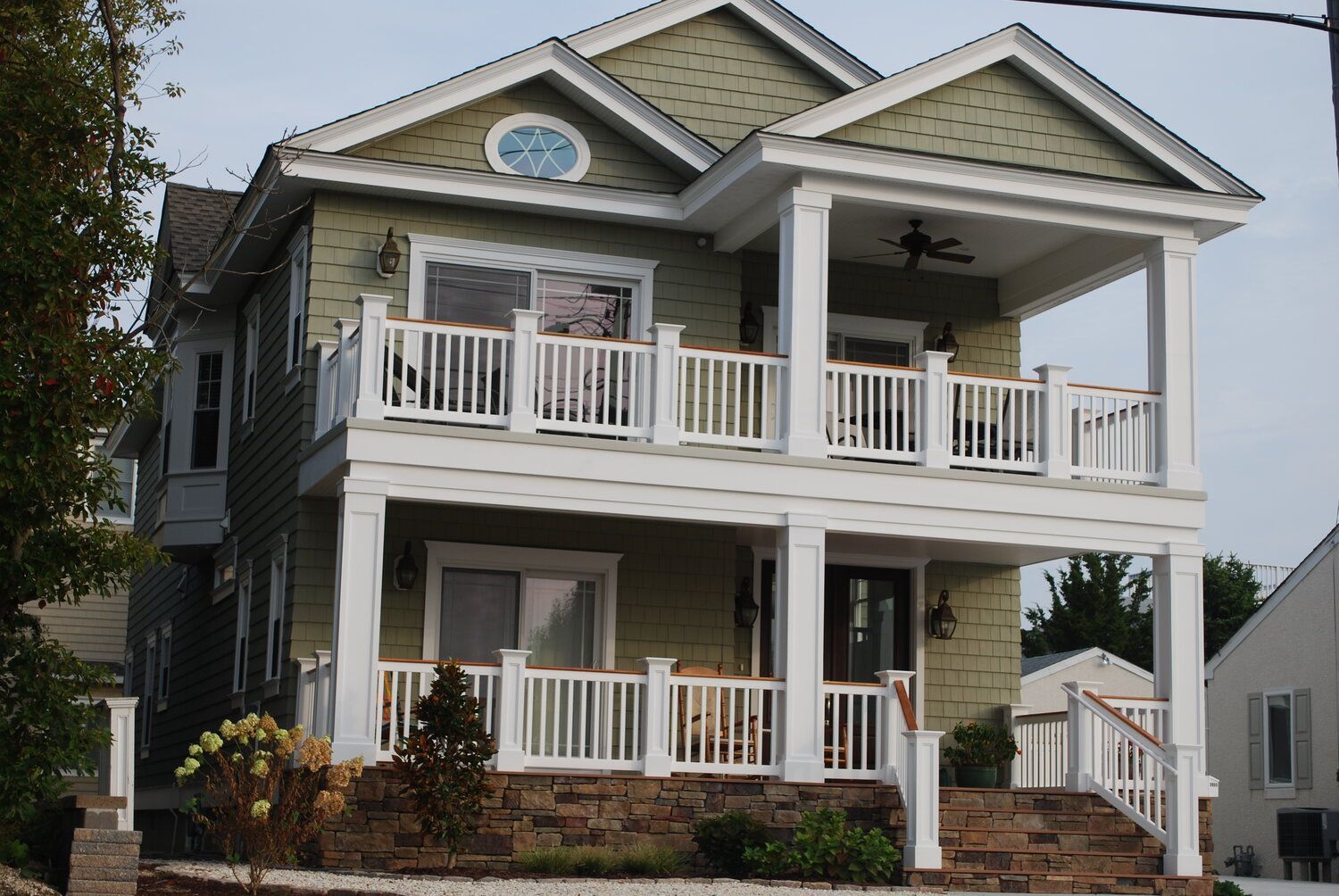 A large house with a large porch and stairs