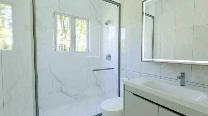 A bathroom with a toilet, sink, mirror, and shower.